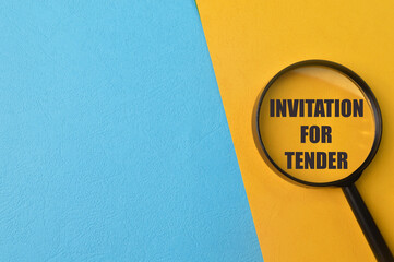 Magnifying glass with phrase INVITATION FOR TENDER isolated on yellow background