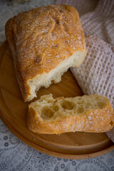 sliced ​​ciabatta on a wooden board on the table