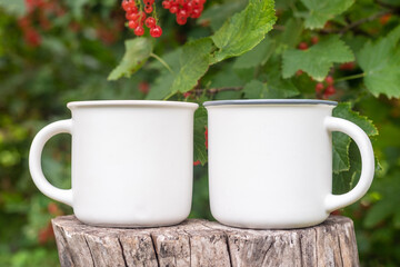 Two Mugs mockup with bokeh green nature. Farmhouse rustic style. White coffee cup mock up. Blank mug printing design template.