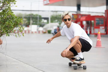 Fototapeta premium young man skater riding on skateboard
