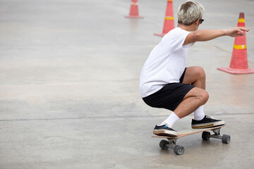 Fototapeta premium young man skater riding on skateboard