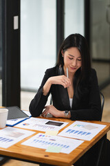 Portrait Of Attractive Asian Businesswoman Working for marketing plan. business analysis,financial...