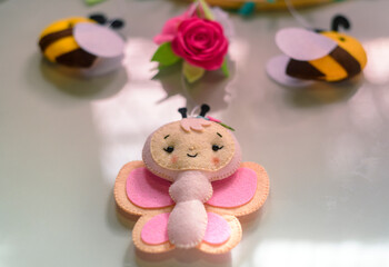 Cute prop for baby cot mobile closes up. Felt plush bees with flowers design.