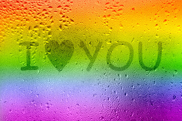 The inscription on the sweaty glass. The word I LOVE YOU written on glass with rainbow