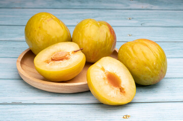 Fresh green plum, Granate Plum on wooden background.