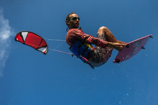 A kite surfer rides the waves
