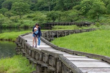 Mother and daughter hug during afternoon walk