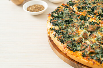spinach and cheese pizza on wood tray