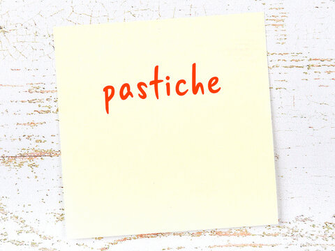 Yellow Sticky Note On Wooden Wall With Handwritten Word Pastiche