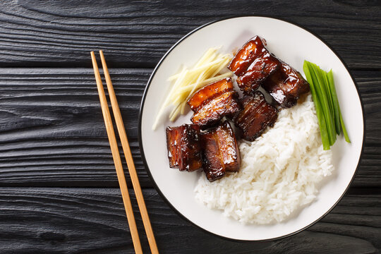 Okinawan Braised Pork Belly dish called Rafute closeup in the plate on the table. Horizontal top view from above