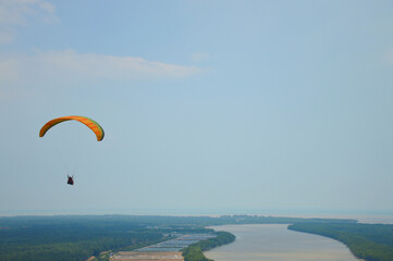 The paragliding fly in the sky.