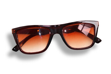 A pair of plastic sunglasses with orange lenses on a white background