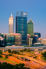 Naklejka premium Downtown Perth city and the Mitchell Freeway viewed at sunset from Kings Park. Perth is a modern and vibrant city and is the state capital of Western Australia, Australia.