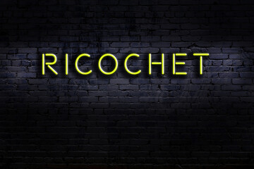 Neon sign. Word ricochet against brick wall. Night view