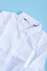 A white shirt with autumn leaves in the pocket. Back to school concept.
