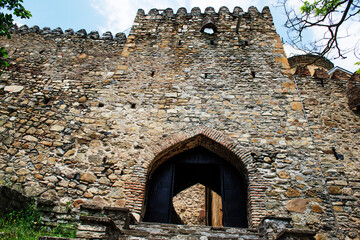 Ananuri fortress. Stone wall. Arched entrance.