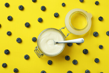 Concept of tasty breakfast with yogurt on yellow background