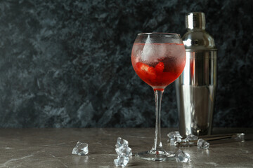 Shaker and glass of fresh summer cocktail on gray table