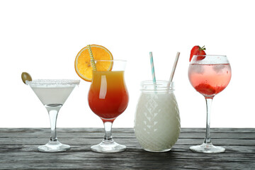 Different cocktails on wooden table isolated on white background