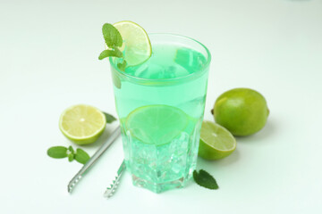 Fresh lime cocktail and ingredients on white background