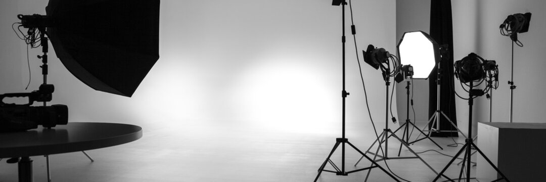 photographic studio with lighting backdrop and various equipment for photos and video shooting. banner