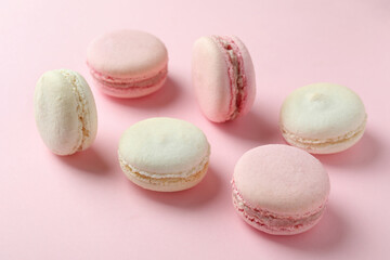 Concept of tasty dessert with macaroons on pink background