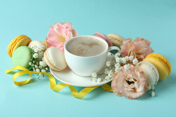Concept of tasty dessert with macaroons on blue background
