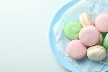 Concept of tasty dessert with macaroons on white background
