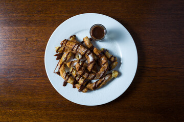 dish with Churros and chocolate, typical Spanish sweets. top view