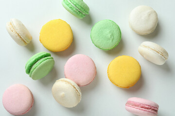 Concept of tasty dessert with macaroons on white background