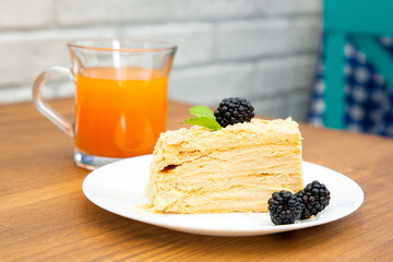 cake on a plate and a glass of orange juice. Food concept.