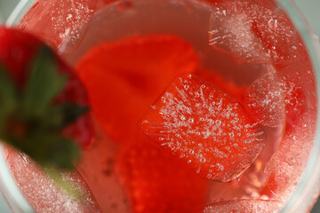 Glass of fresh strawberry cocktail with ice, macro