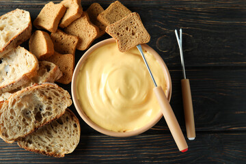 Concept of delicious food with fondue on wooden table