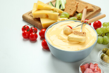 Concept of delicious food with fondue on white background