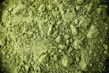 Obraz premium Bowl of green powdered matcha, close up