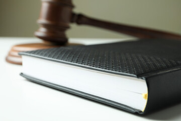 Judge gavel and law book on white table