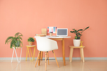 Stylish workplace of graphic designer with laptop in office