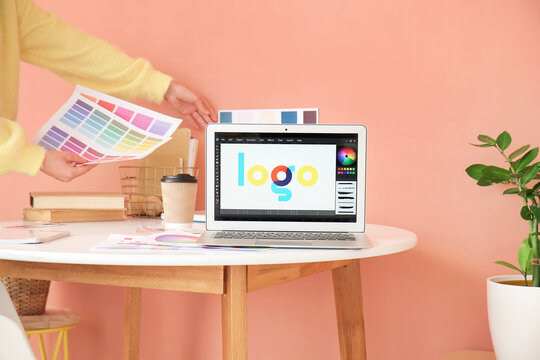 Modern laptop on table of graphic designer in office