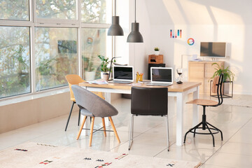 Stylish workplace of graphic designers with laptops in office
