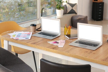 Stylish workplace of graphic designers with laptops in office