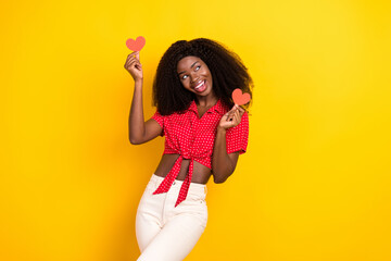 Photo of nice optimistic brown hair lady hold heart look empty space wear shirt isolated on yellow color background