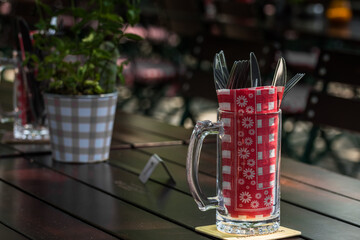 glass with cutlery on a table in a beer garden