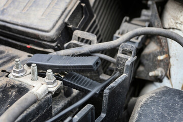 Jumper cable (booster cable) in car.