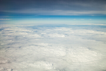 Fototapeta na wymiar Clouds and sky as seen through window of an aircraft