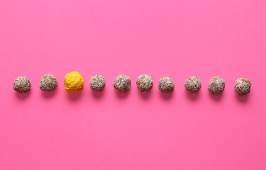 Tasty candies on color background. Concept of uniqueness