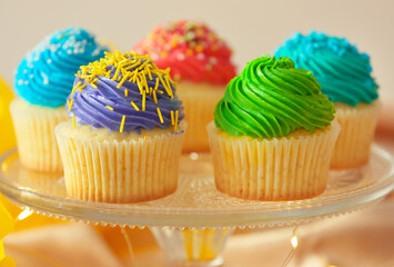 Stand with tasty Birthday cupcakes on color background, closeup
