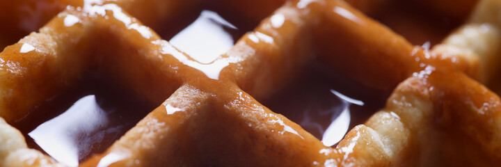 Closeup of delicious Viennese waffles with caramel syrup