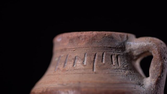 closeup macro  old jar spinning in the dark on a spotlight
