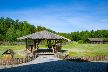 Beautiful wooden gazebo in eco style in a summer park