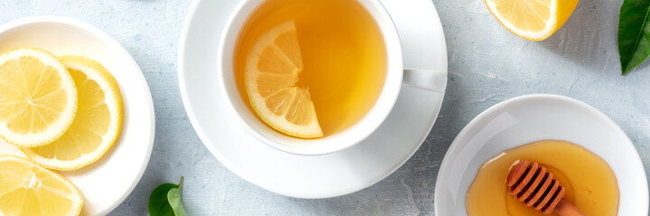 Lemon tea and honey panorama, shot from the top with fresh organic lemons. Healthy organic drink...